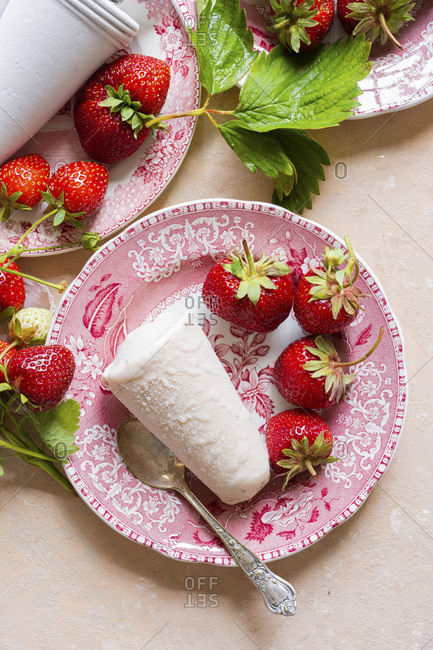 Strawberry Kulfi served on pink china plates , pink linen with fresh picked strawberries.