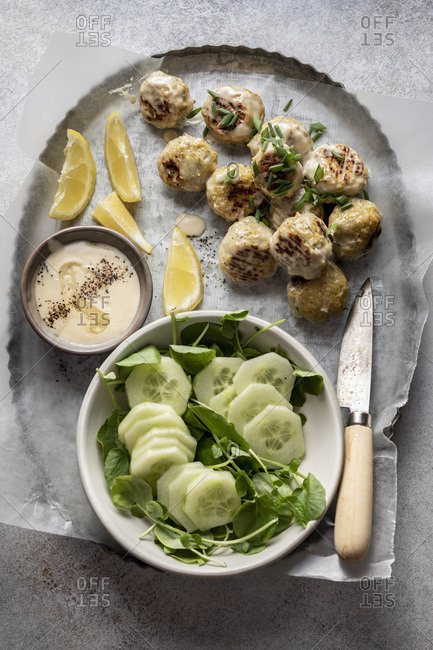 Swedish meatballs with cucumber watercress salad and creamy sauce served in a tray