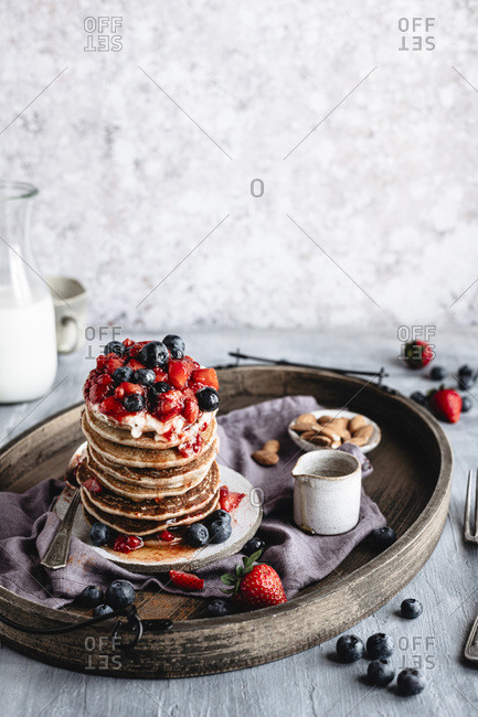 A stack of gluten free pancakes garnished with berries