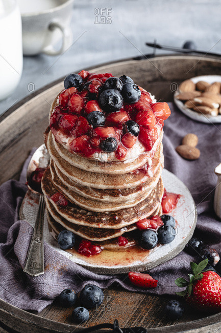 A closeup shot of gluten free pancakes with berries