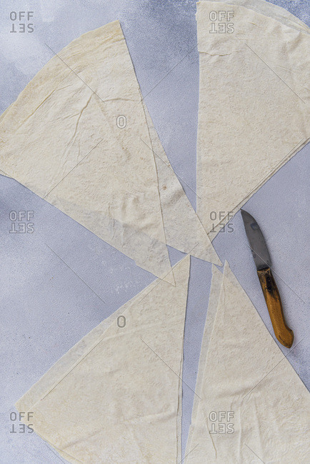 Phyllo sheets are cut in triangles for borek making
