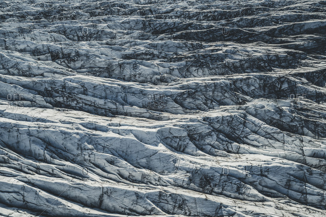 An aerial view of Svinafellsjokull glacier. The black lines or striations in the ice are from ash from past volcanic eruptions.