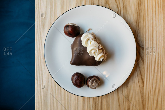 Gourmet chocolate dessert and chestnuts on a plate