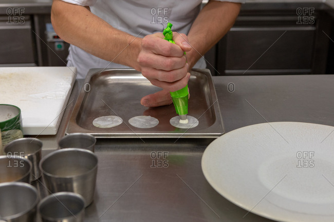 Chef preparing gourmet dish in restaurant kitchen