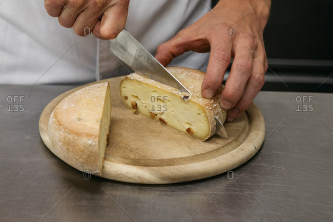 Slicing a wheel of cheese Stock Photo by ©photography33 82250564