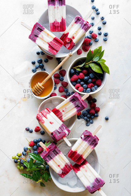 Mixed Berry Popsicles set with fresh berries on ice