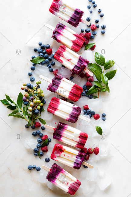Mixed Berry Popsicles set with fresh berries on ice