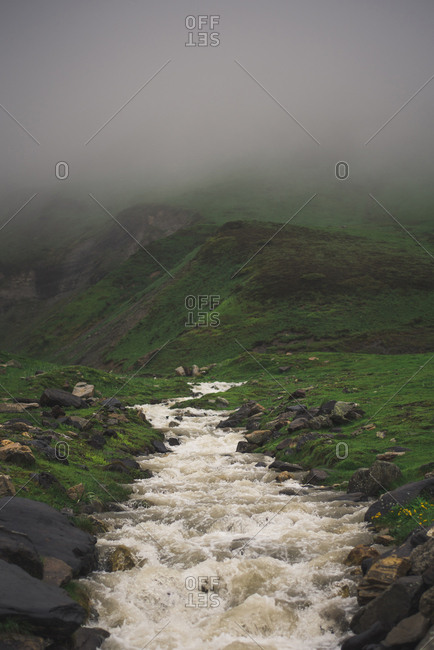 Scenic view of river flowing during foggy weather