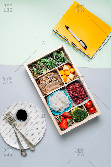 Food box with diet ingredients by copybook and plate