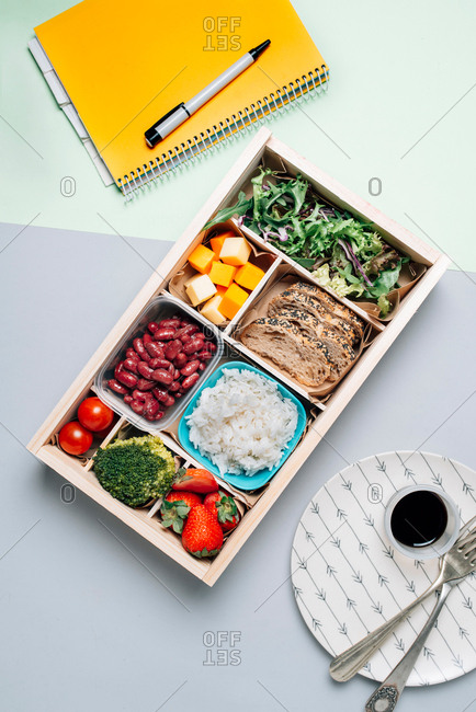 Food box with diet ingredients by copybook and plate