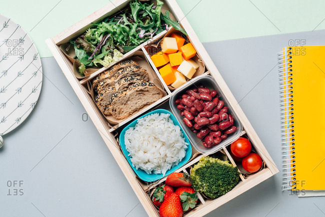 Food box with diet ingredients by copybook and plate
