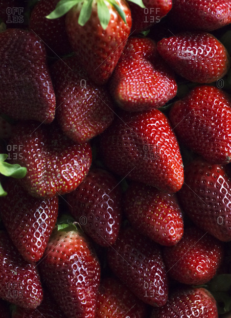 From above clean healthy ripe strawberries placed in pile