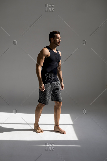 Athlete standing in sunlit studio