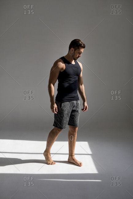Athlete standing in sunlit studio