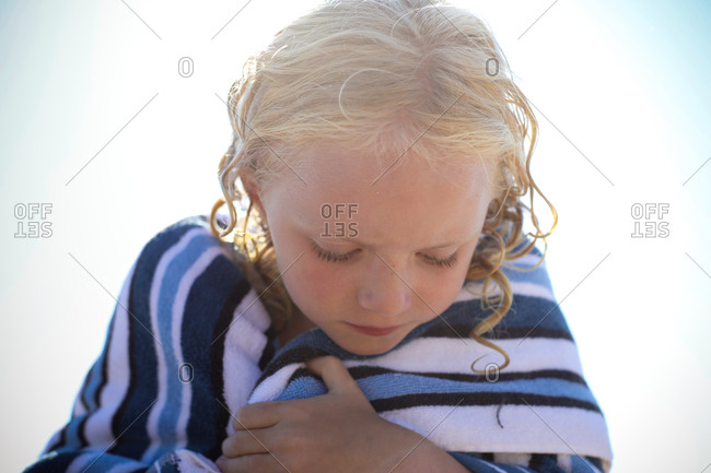 Girl looking down wrapped in towel
