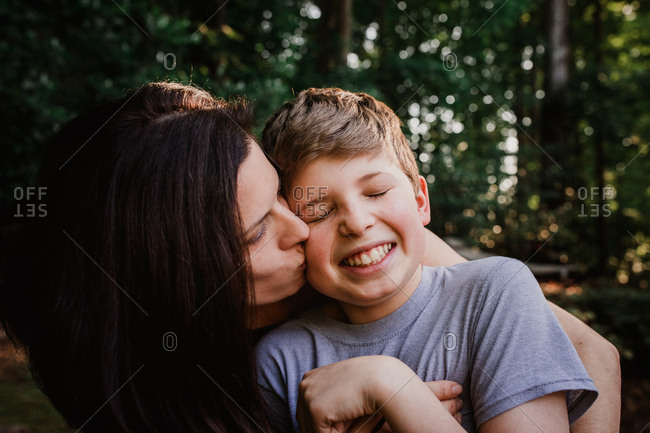 Mom kissing her son