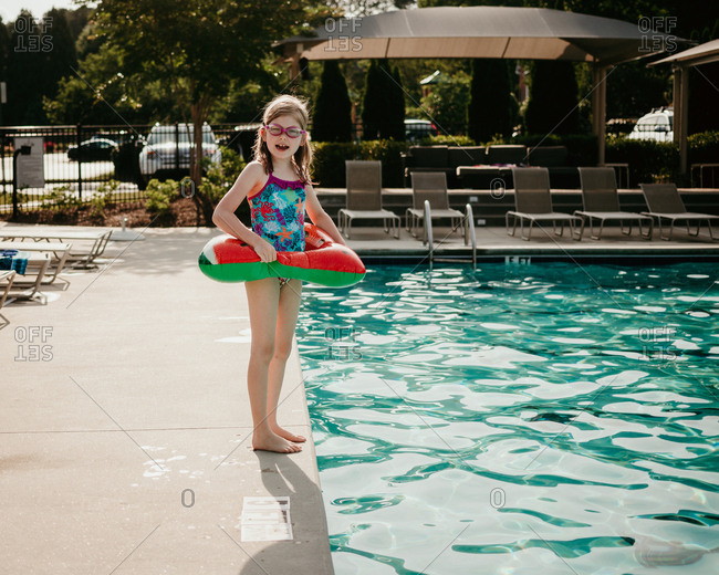 Little girl getting ready to jump into the pool
