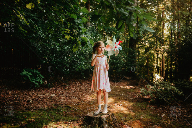 Girl in the forest with a pinwheel