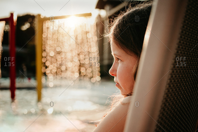 Girl sitting near a pool water fall