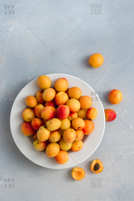Overhead view of freshly picked apricots in plate