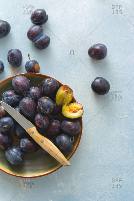 Plate full of sweet freshly picked plums from above