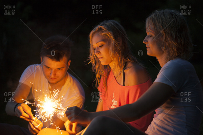 Dancing with sparklers in the evening celebrating summer and having a free spirt