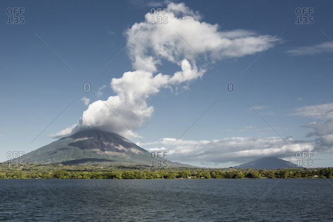 Scenic view of lake by mountains against sky