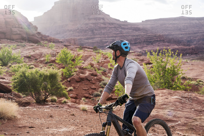 Mountain biker cycling against rock formations
