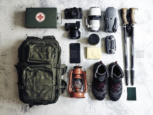 Flat lay of various technologies with climbing equipment arranged on table