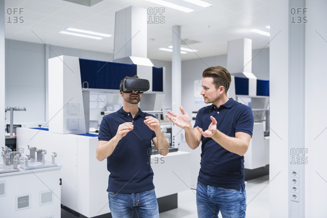 Two men in testing instrument room with VR glasses
