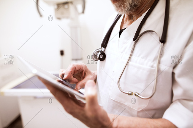 Close-up of vet using tablet in clinic