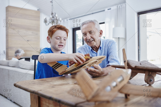 Grandfather and grandson building up model airplanes