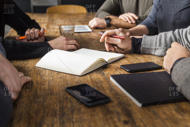 Coworkers working on a project on wooden table
