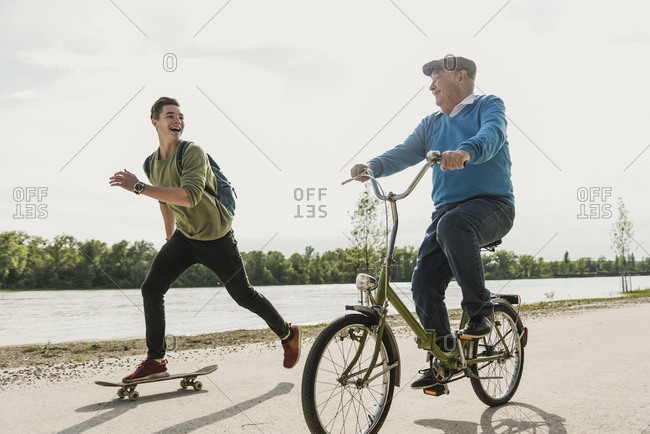 Grandfather and grandson having fun together at riverside