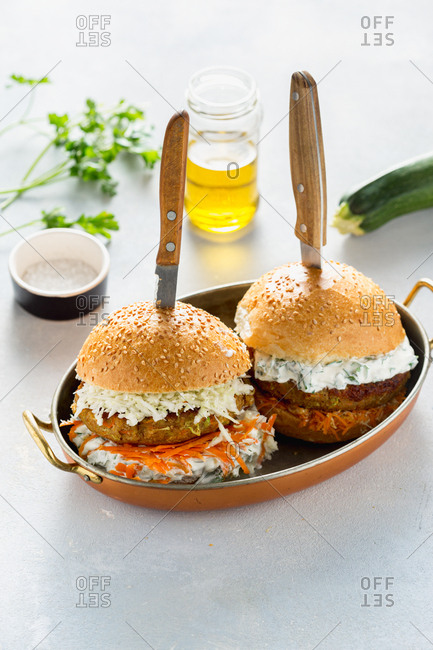 Two vegetarian burgers served in a pan