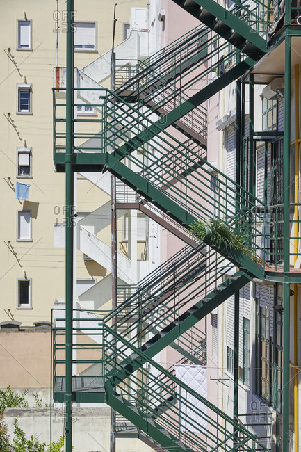 Green fire escape on an apartment building in the city of Lisbon, Portugal