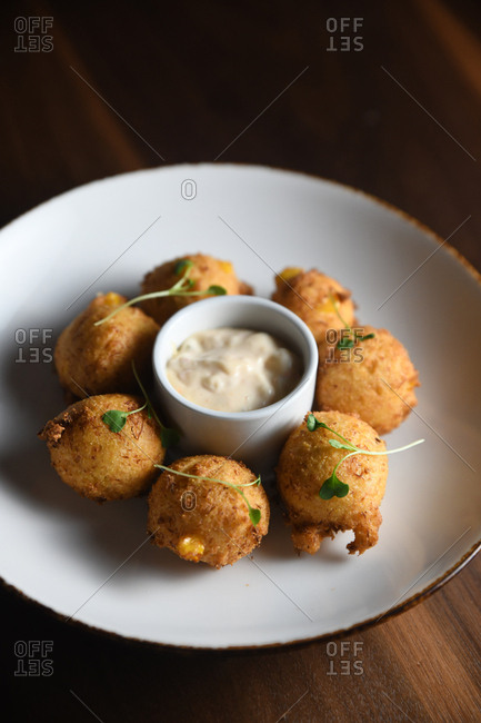 Hushpuppies served with a dipping sauce