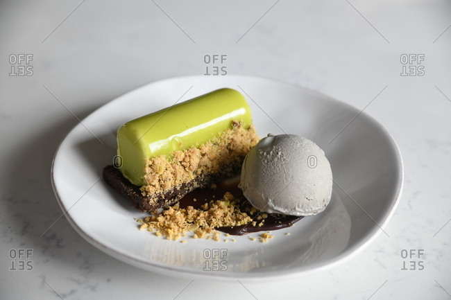 Gourmet green glazed pastry served with ice cream