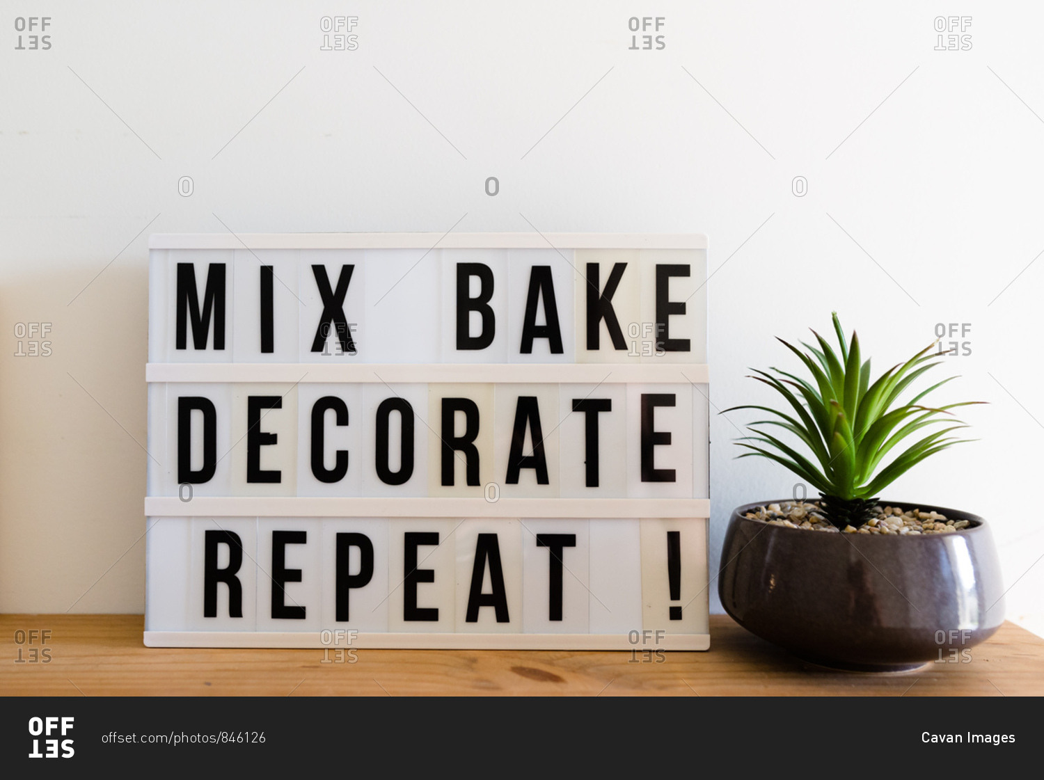A baking sign saying \'mix, bake, decorate, repeat!\'