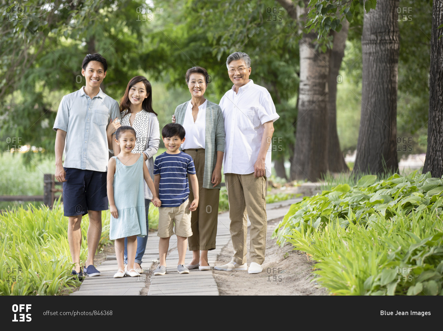 Happy Chinese family relaxing in park