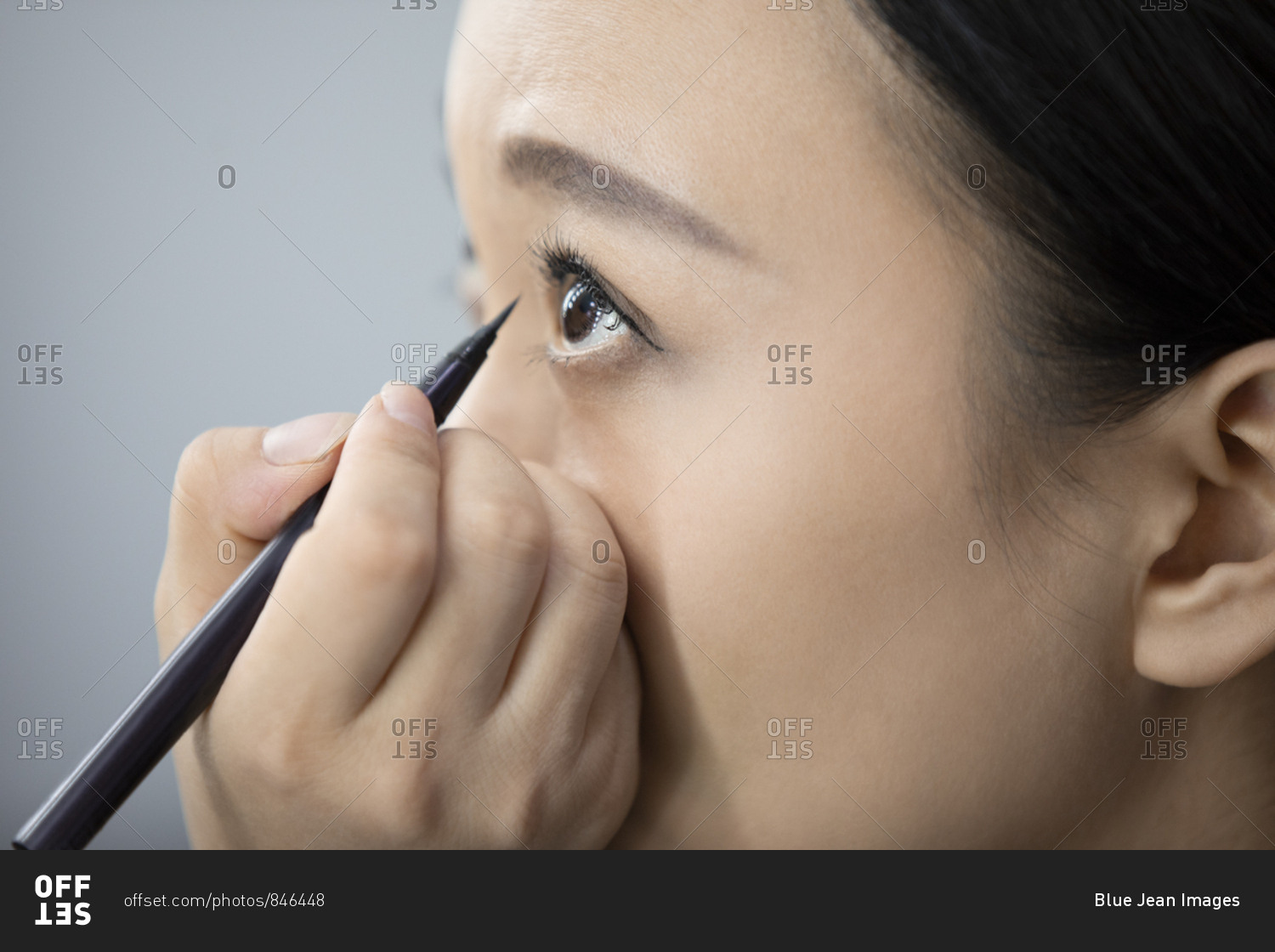 Chinese makeup artist applying makeup on model
