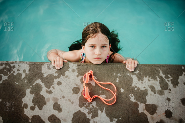 Girl looking up from the pool