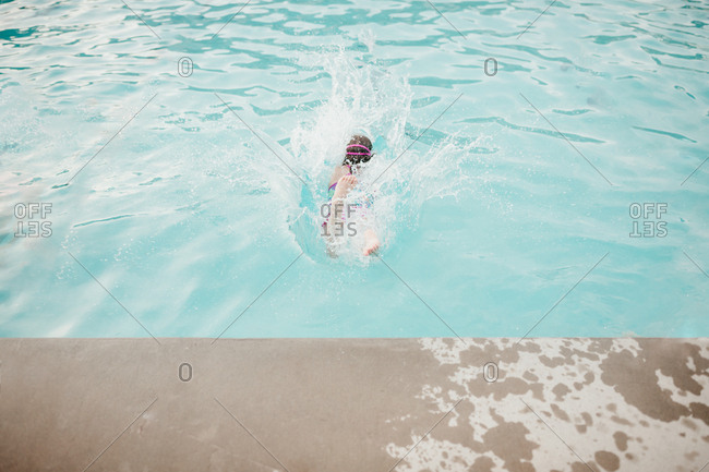 Girl doing a belly flop into the pool