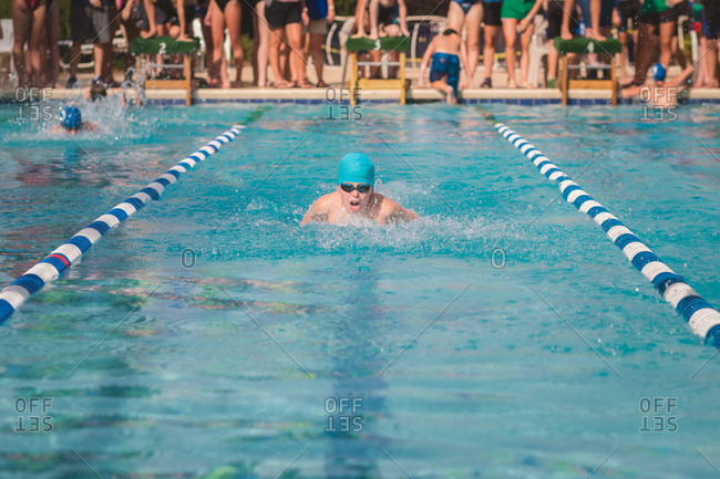 Boy racing at a swim meet