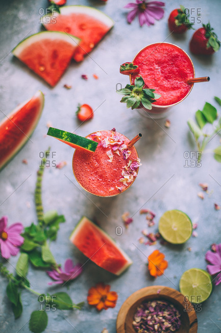 Pink and red fruit cocktails with watermelon and lime.