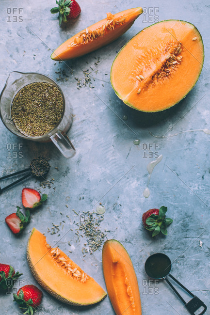 Fresh melon with lavender tea on grey background.