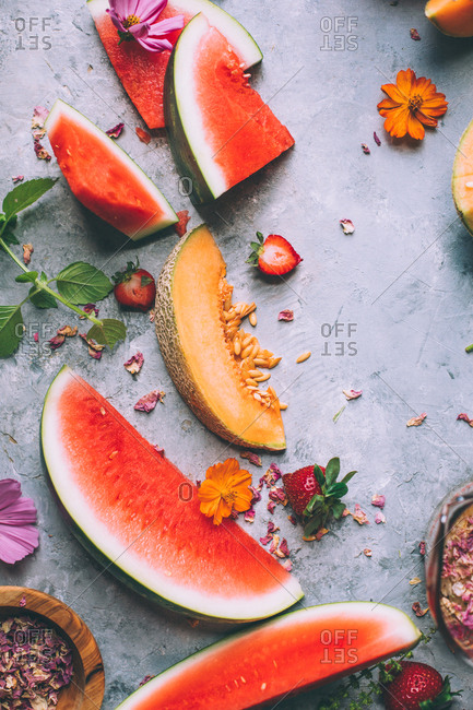 Melon and watermelon on grey background.