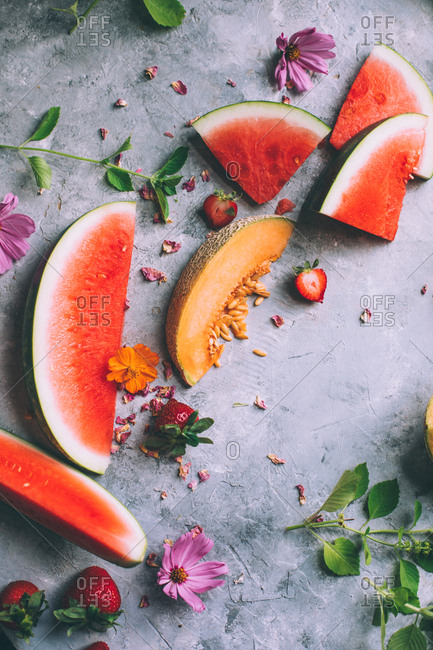 Melon and watermelon on grey background.