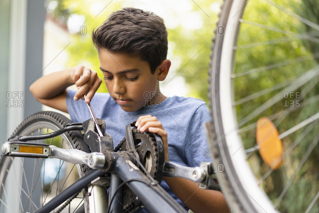 Boy repairing his bicycle