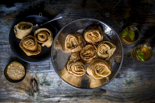 Assortment of sweet Tunisian rolls oudhnin el kadi served with tea